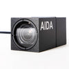 AIDA Imaging weatherproof 3G-SDI 1080p POV camera with 3x optical zoom, designed for multi-purpose use, shown in outdoor setting