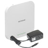 NETGEAR AX1800 wireless dual-band 2.5 Gigabit insight managed access point, front-left view showing sleek design and ports