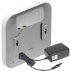 Rear left view of Netgear AX1800 wireless dual-band 2.5 Gigabit insight managed access point, showing ports and ventilation.
